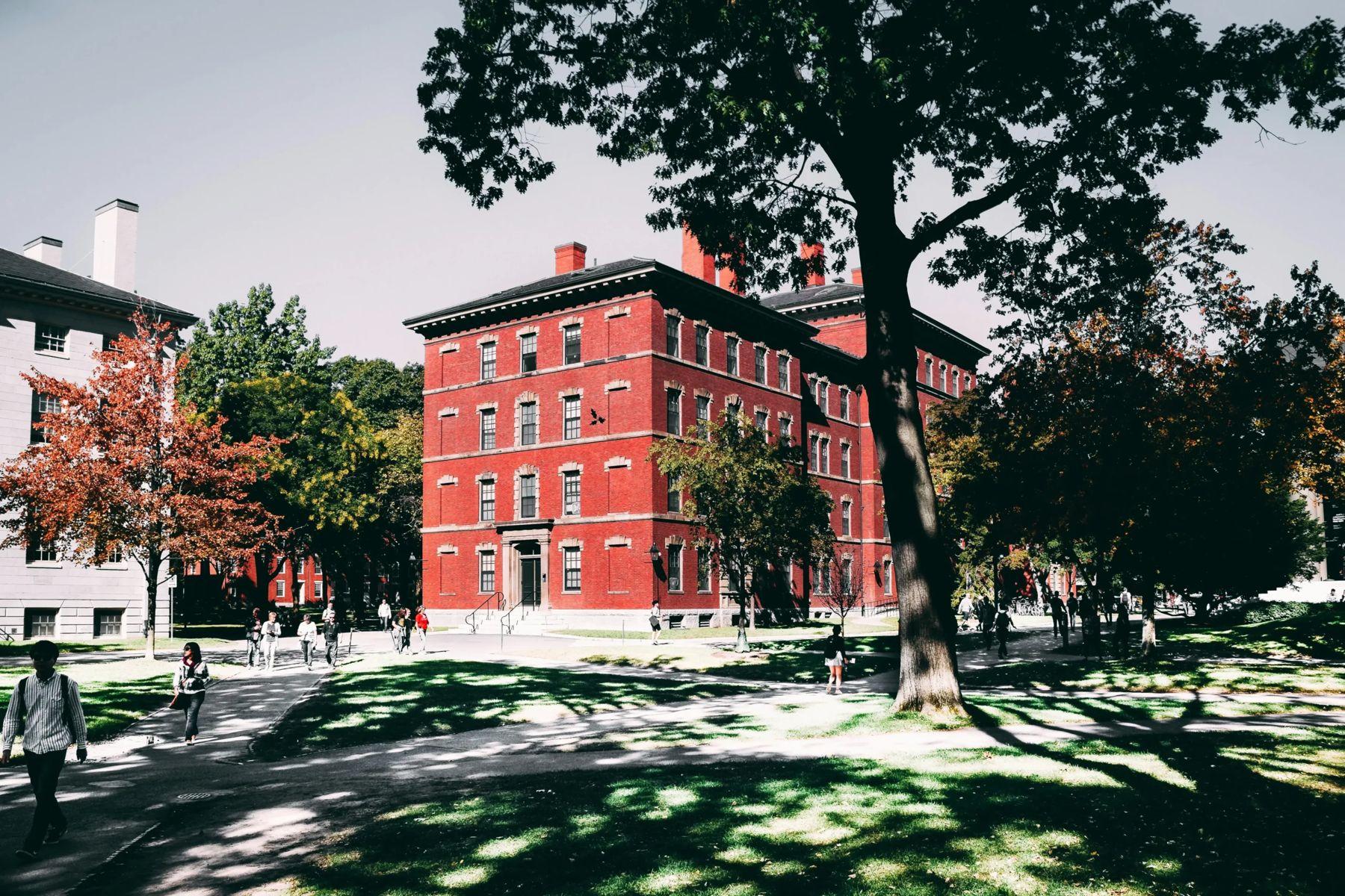 Red-brick university building on a tree-lined campus