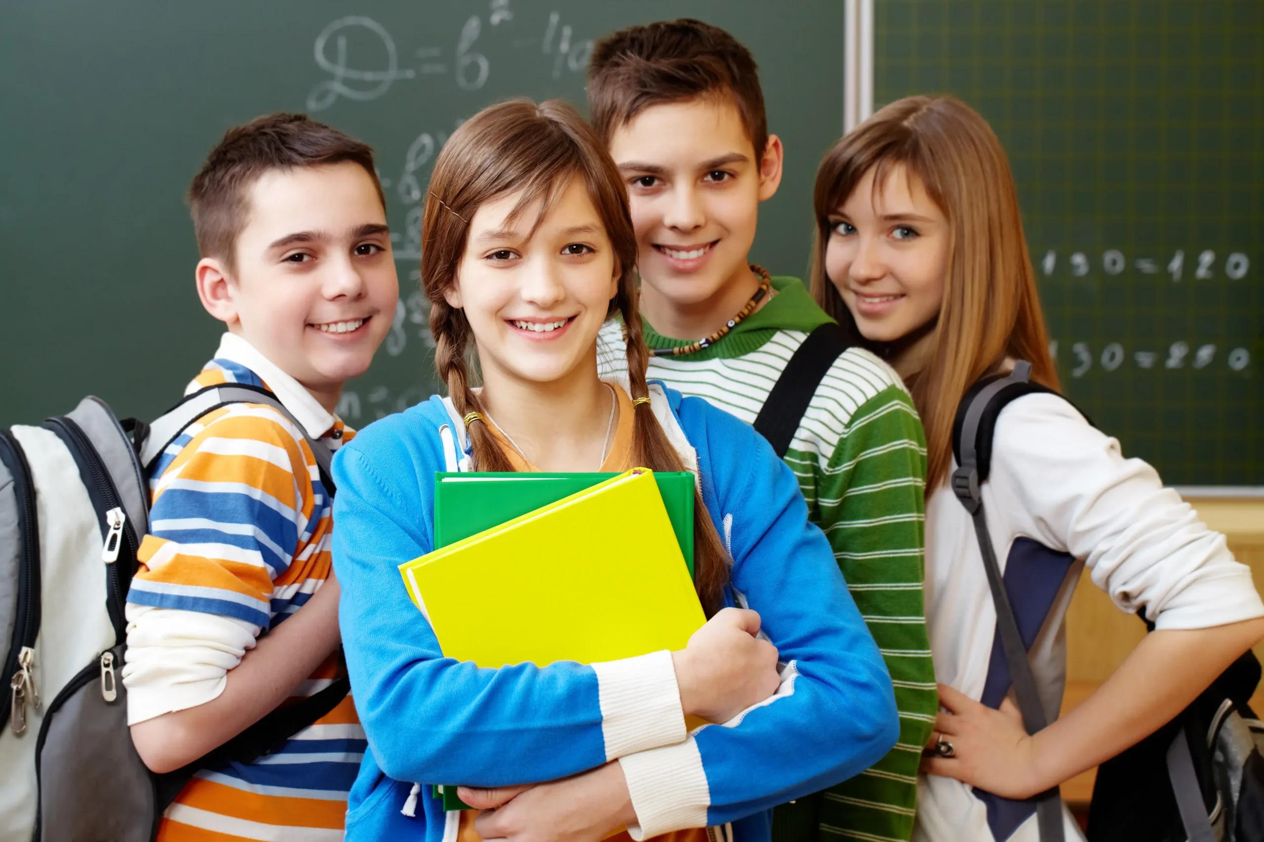 Smiling high school students with backpacks